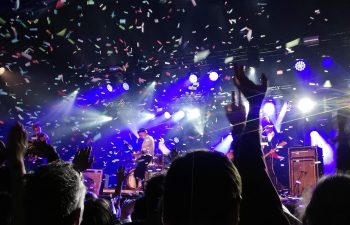 Event at THEA Mackenzie Beach Corporate Celebrations – Energy Meets Elegance Event at THEA Mackenzie Beach. Crowd dancing under confetti and stage lighting during a lively corporate event at THEA Mackenzie Beach.